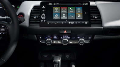 The infotainment screen and AC panel of the Honda Jazz.